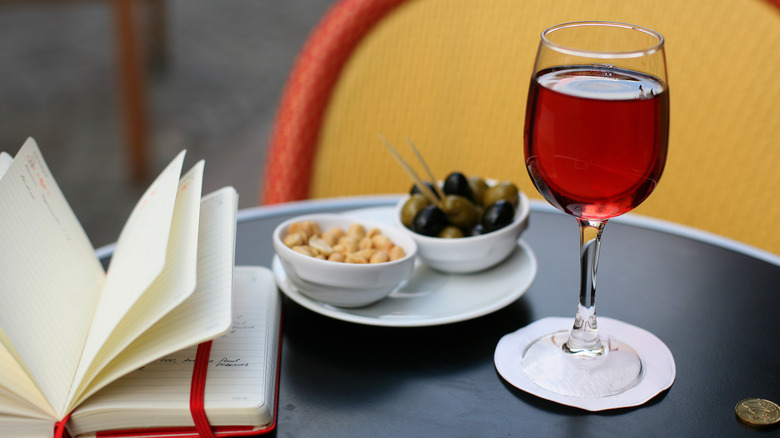 Kir cocktail with snacks on outdoor table