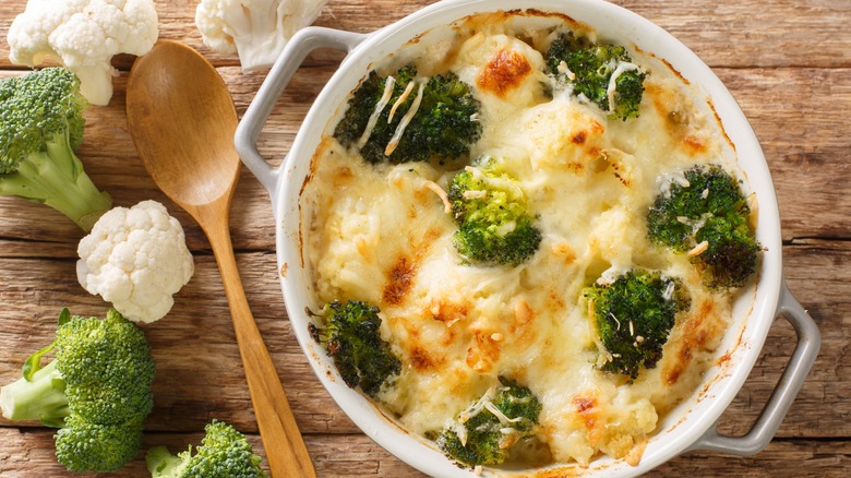 Cauliflower and broccoli melted cheese casserole in white pot