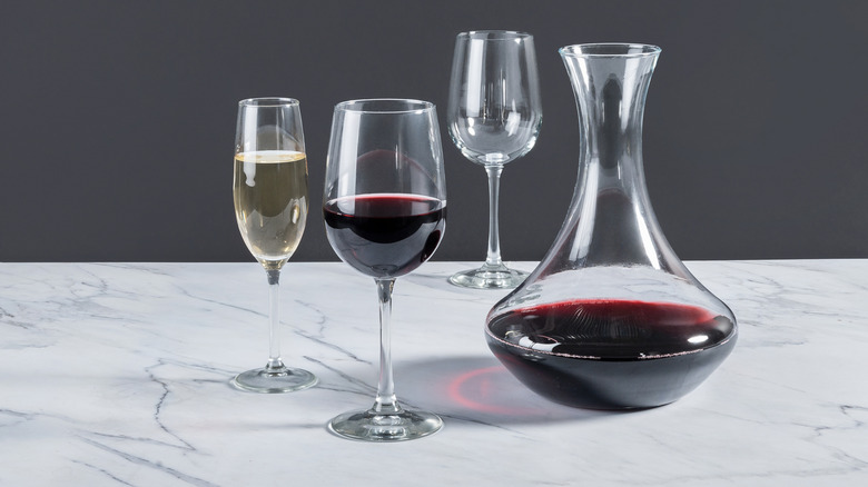 white and red white in glasses beside a decanter