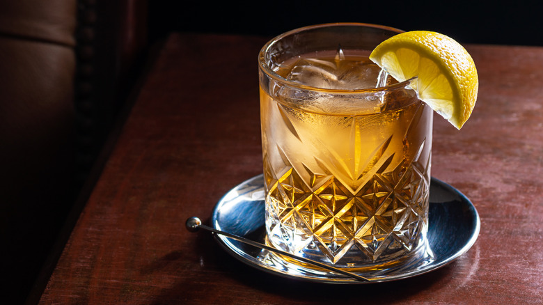 Glass of Scotch and soda garnished with lemon