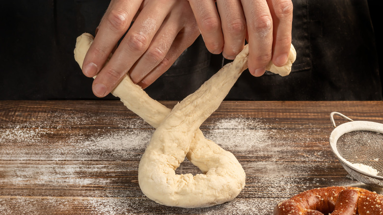 hands shaping pretzels