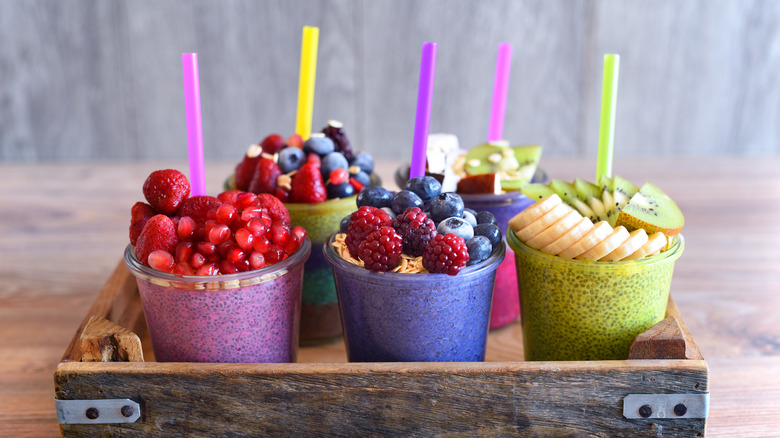 Five fruit smoothies in a wooden tray