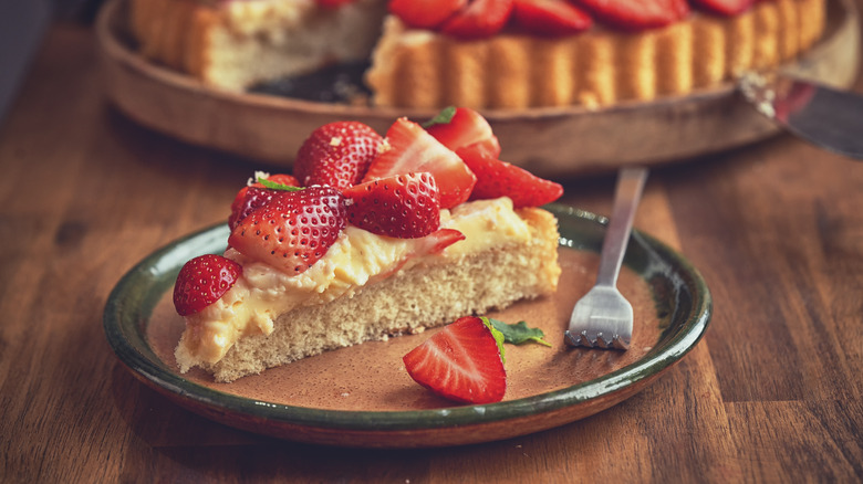 Strawbery tart on plate with metal fork