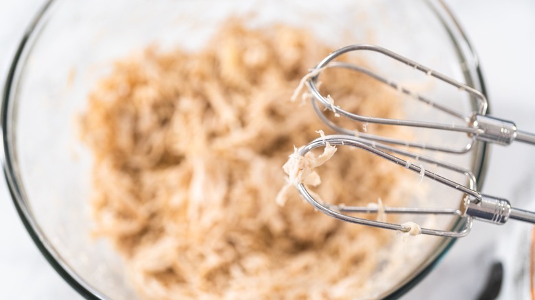 Hand mixer used to shred chicken