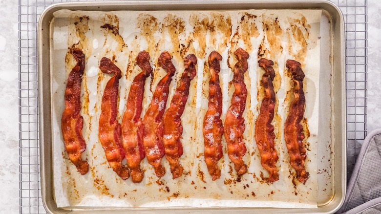 cooked bacon on parchment lined sheet pan