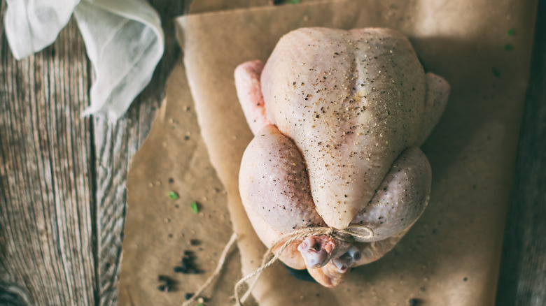 a whole chicken seasoned with salt and pepper