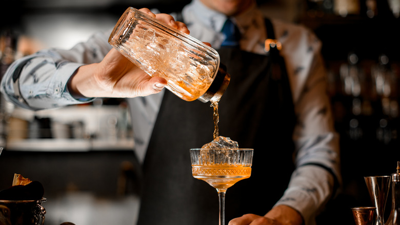 a barman pouring a cocktail