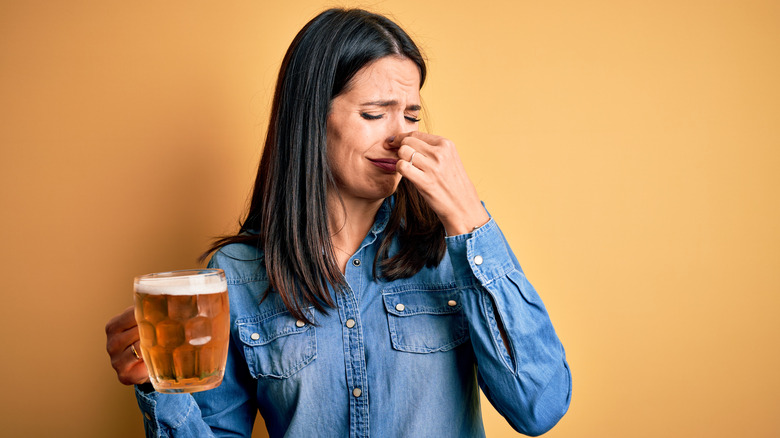 a woman struggling with a beer