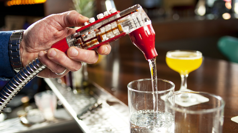 bartender pouring water in glass