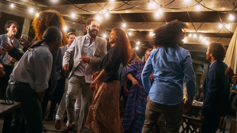 friends having fun on dance floor with Edison lights