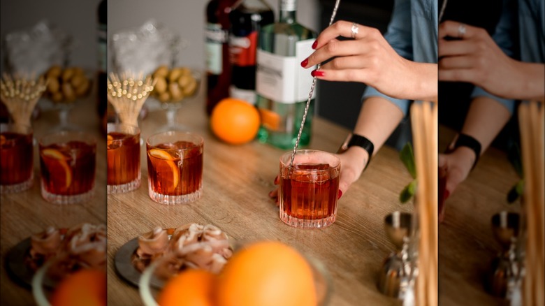 Woman's hands stirring cocktail