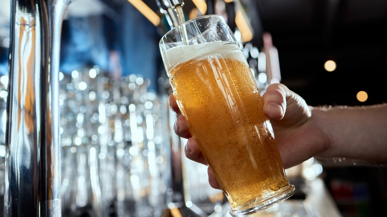 Beer glass being filled from a tap