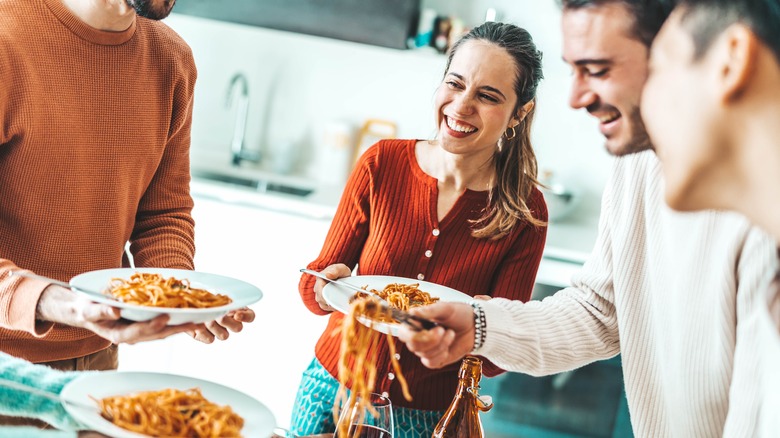 friends eating pasta at home