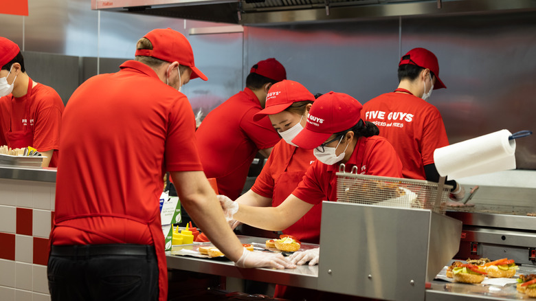 Five Guys employees preparing food