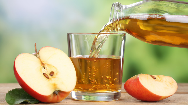 Pouring apple juice into glass 