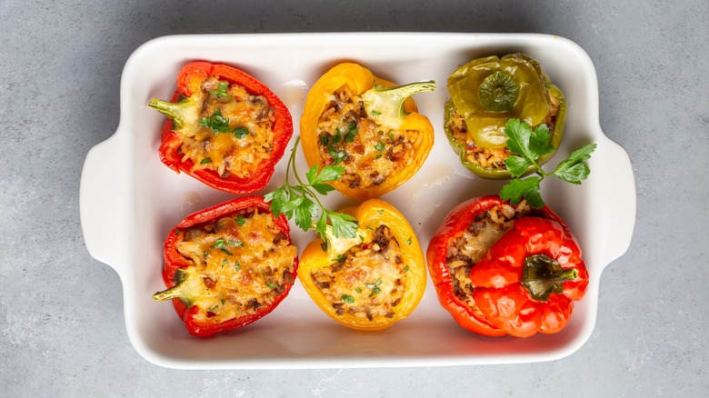 Stuffed bell peppers in white baking dish