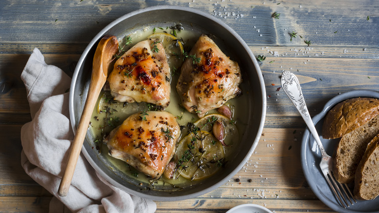Chicken thighs in pan with white wine sauce