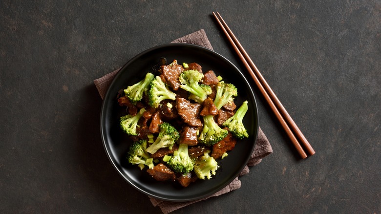 A bowl of takeout-style beef and broccoli