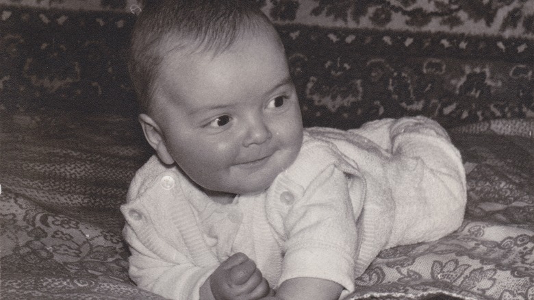 Vintage black-and-white photo of a baby on its tummy