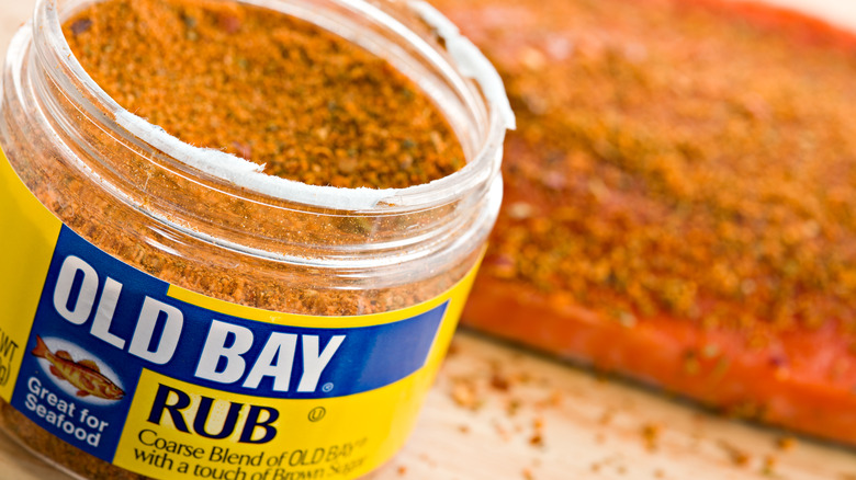 An open jar of Old Bay seasoning rub