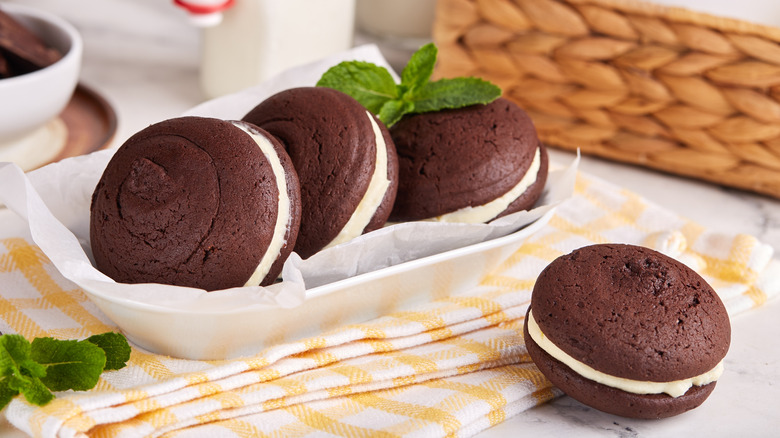 Several homemade moon pies sit on a table.