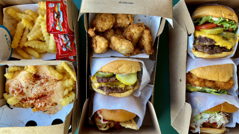 Shake Shack burgers, chicken sandwiches, chicken nuggets, and french fries boxed up together