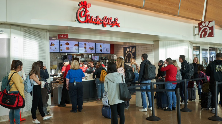 Travelers line up at a Chick-fil-A in San Jose International Airport in California