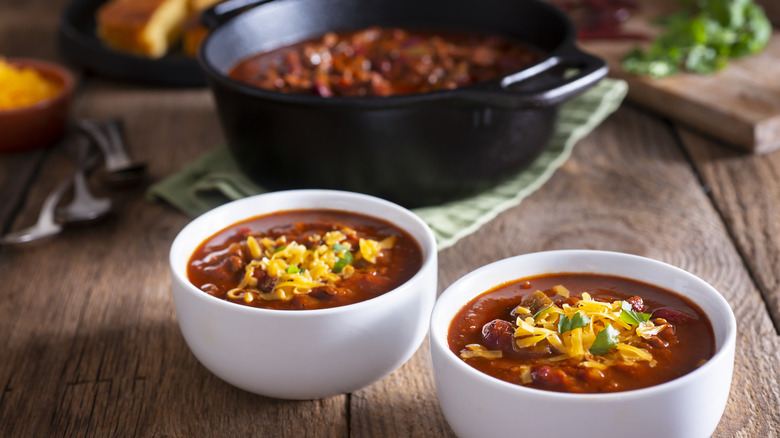 Two bowls and pot of chili