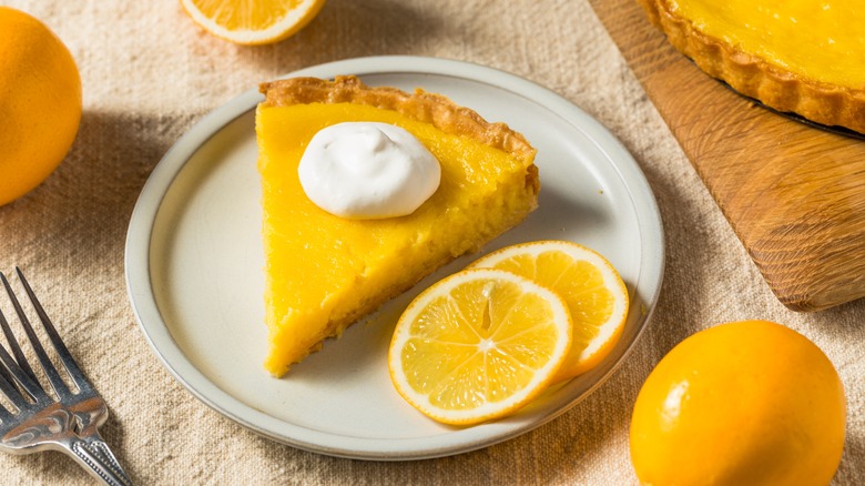 Slice of lemon tart with whipped cream 