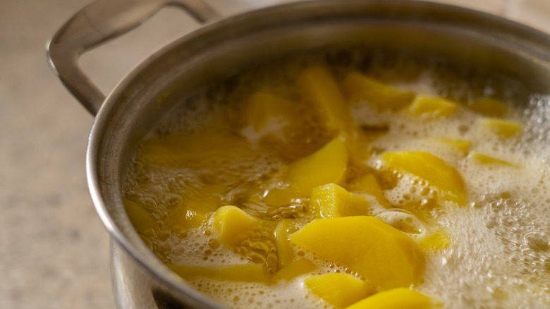 yellow potatoes boiling in pot