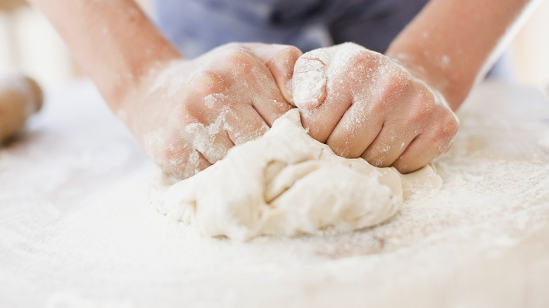 hands kneading bread