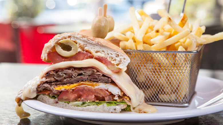 Chivito sandwich with fries