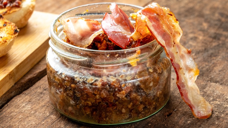 Jar of bacon jam with bacon garnish