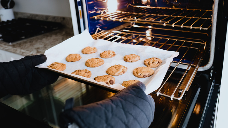 Putting cookies in the oven