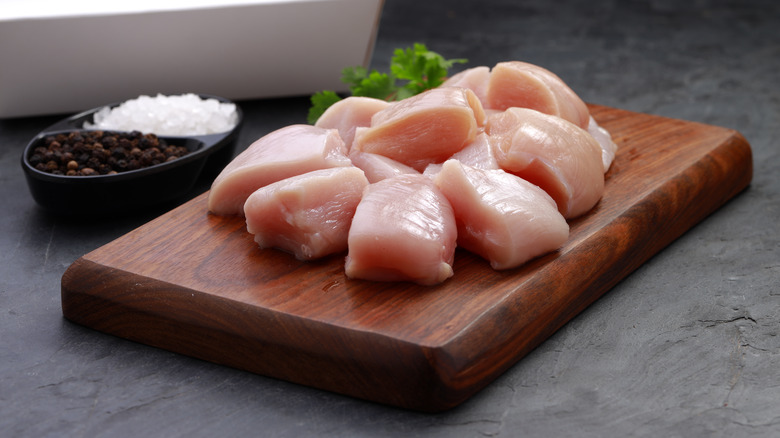 raw chicken tenders on cutting board