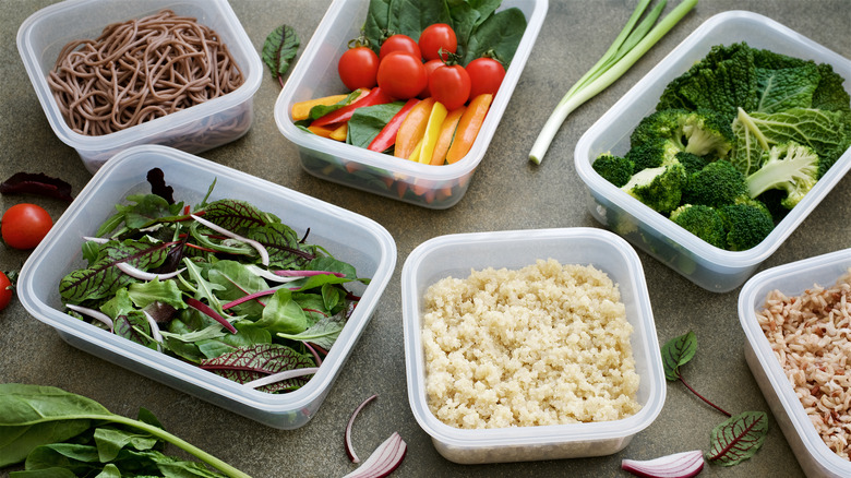 meal prep containers with fresh vegetables and cooked grains