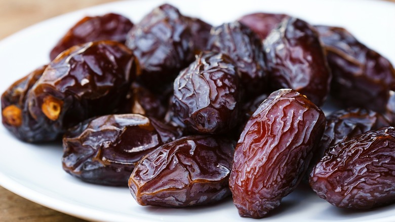 Close-up of medjool dates on white plates