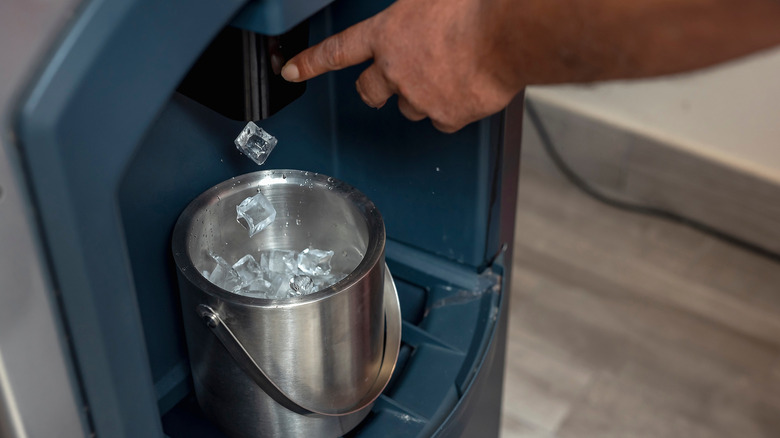 Person adding ice to ice bucket