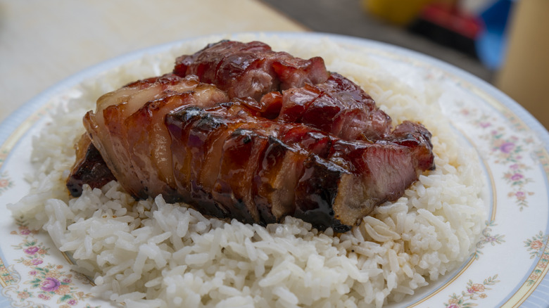 Char siu over rice on flower-painted plate