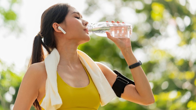 Athletic person drinking water