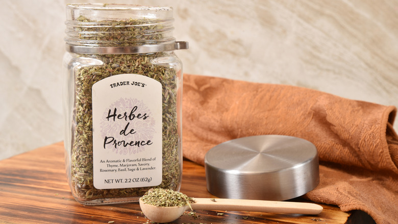 an open jar of herbes de Provence from Trader Joe's sits on a table