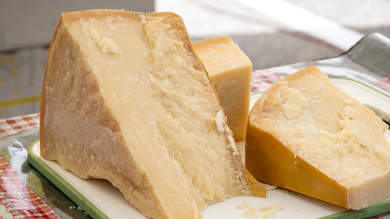 Wedges of Parmigiano Reggiano on a cutting board