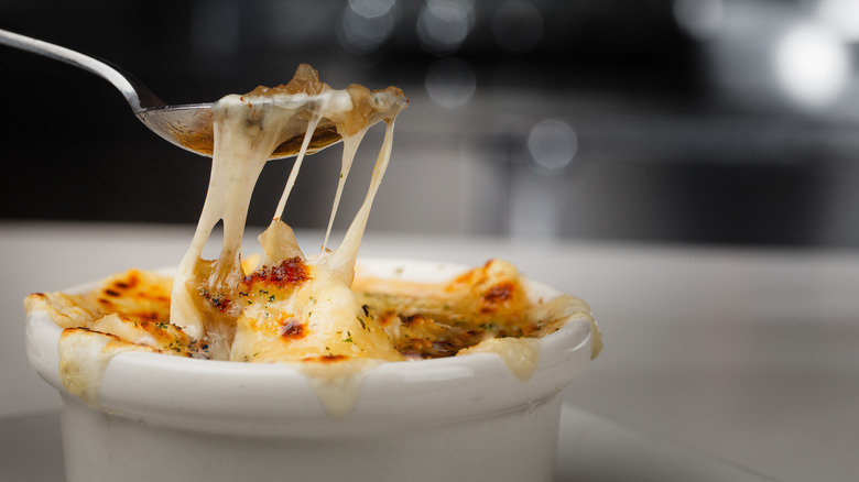Bowl of French onion soup with melted cheese-pull