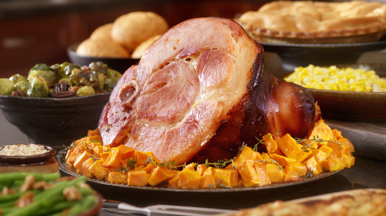 bone-in ham with accompanying side dishes