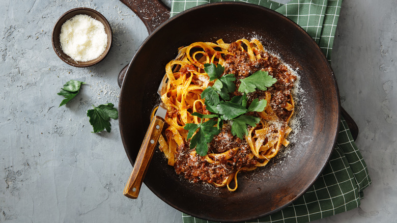 Bowl of pasta with bolognese and parsley  