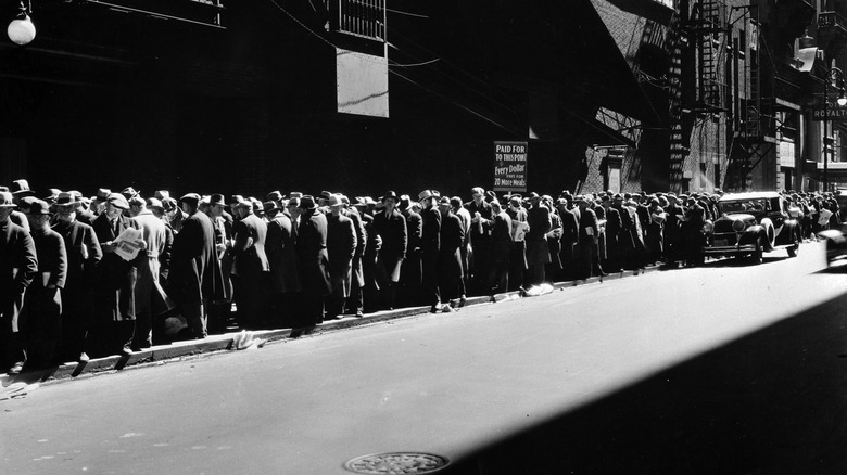 During the Great Depression, a large group of men line up to receive five cent meals in1930s.
