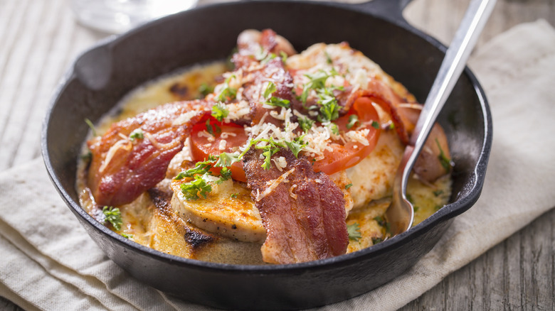 Hot Brown sandwich with bacon, parmesan, and herbs served in a cast iron skillet