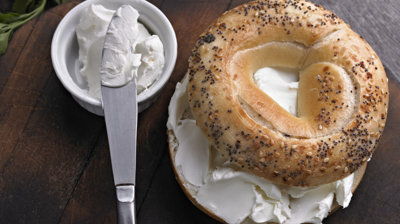 bagel with cream cheese and bowl of cream cheese