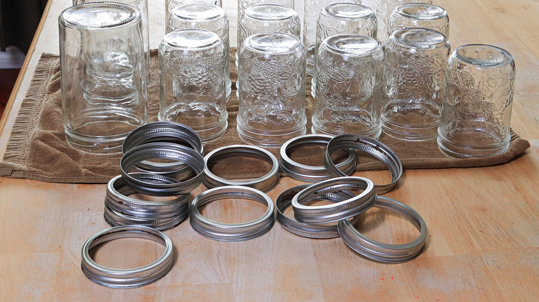 Glass jars and screw bands on table