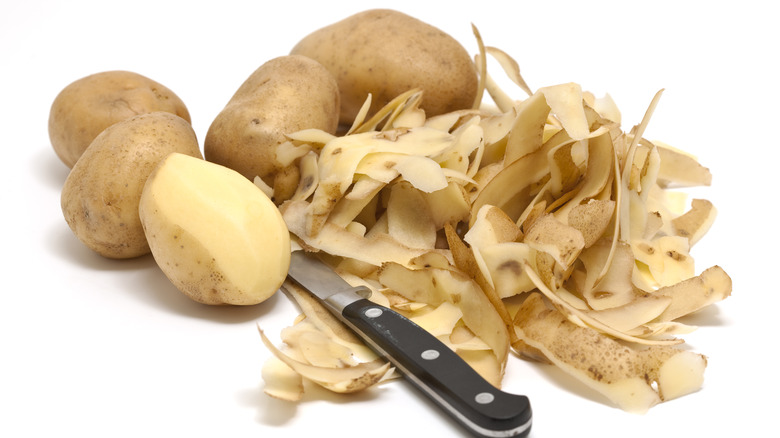 peeled potatoes with paring knife